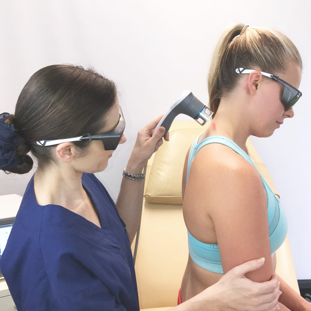 Lady receiving laser treatment on her neck